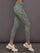 Green marbled leggings worn by a person on a gray background