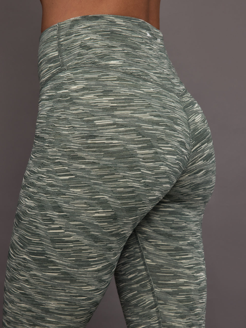 Green patterned leggings on a gray background
