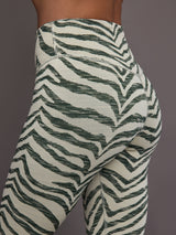 Green Zebra print leggings on a neutral background