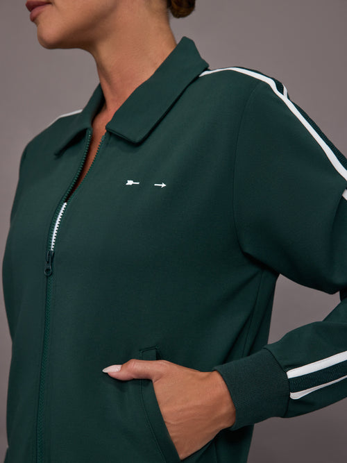 Green tracksuit with white stripes on a gray background