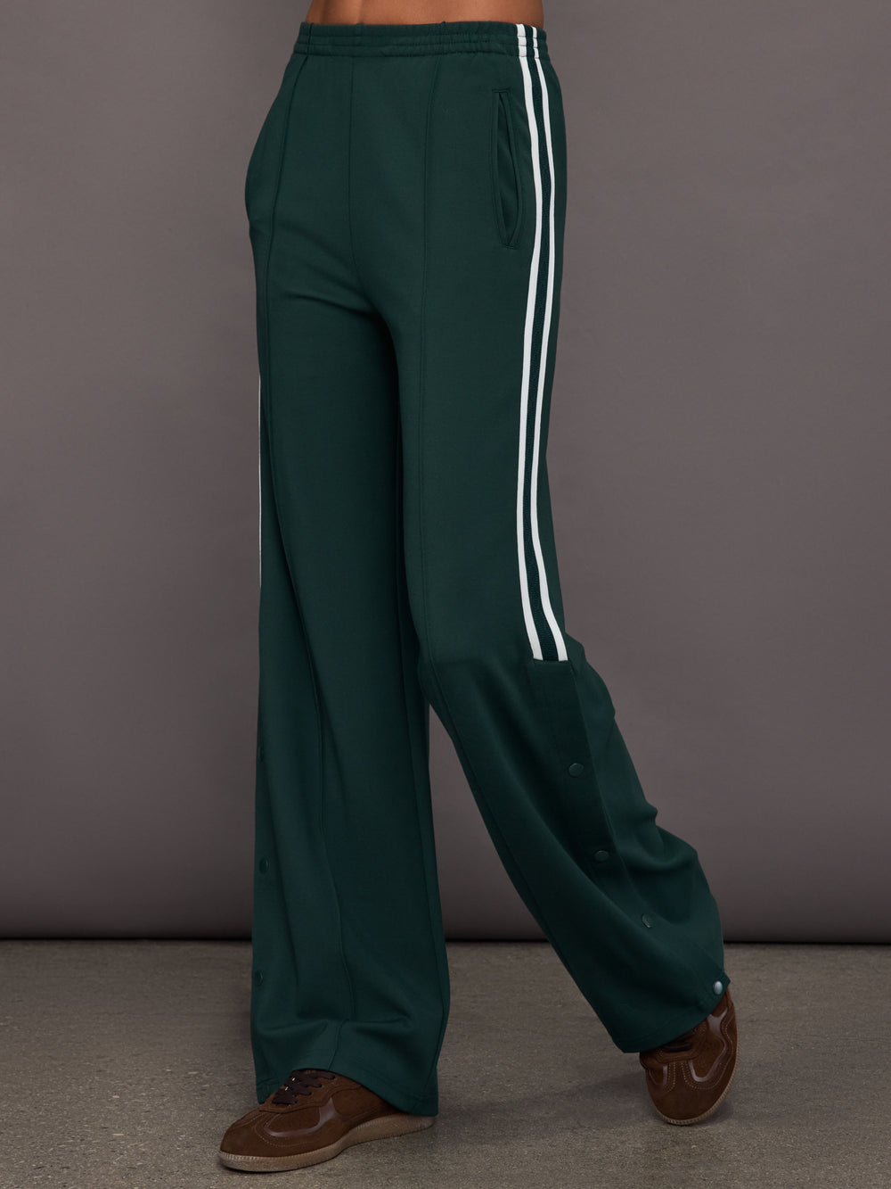 Green wide-leg track pants with white stripes 
