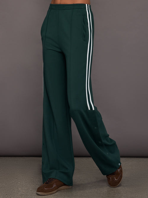 Green wide-leg track pants with white stripes 