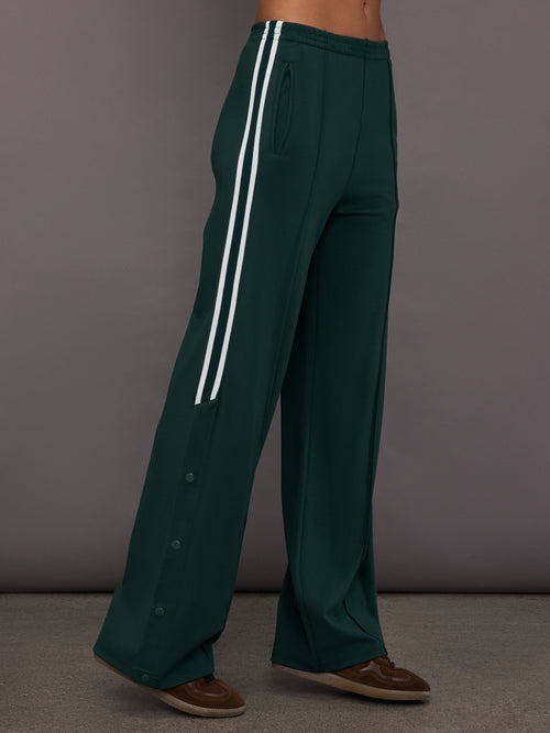 Green wide-leg track pants with white stripes 