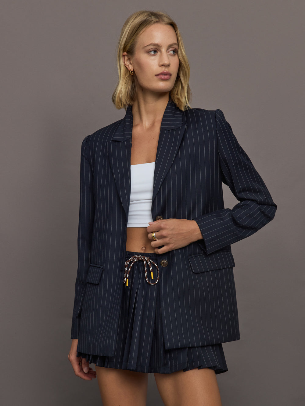 Model wearing a navy pinstripe blazer