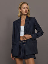 Model wearing a navy pinstripe blazer