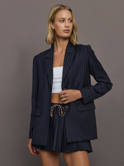 Model wearing a navy pinstripe blazer