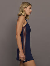 Model wearing a navy blue dress with white and brown stripes