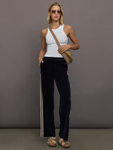 Model wearing Navy velvet pants with white stripes