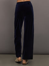 Model wearing Navy velvet pants with white stripes