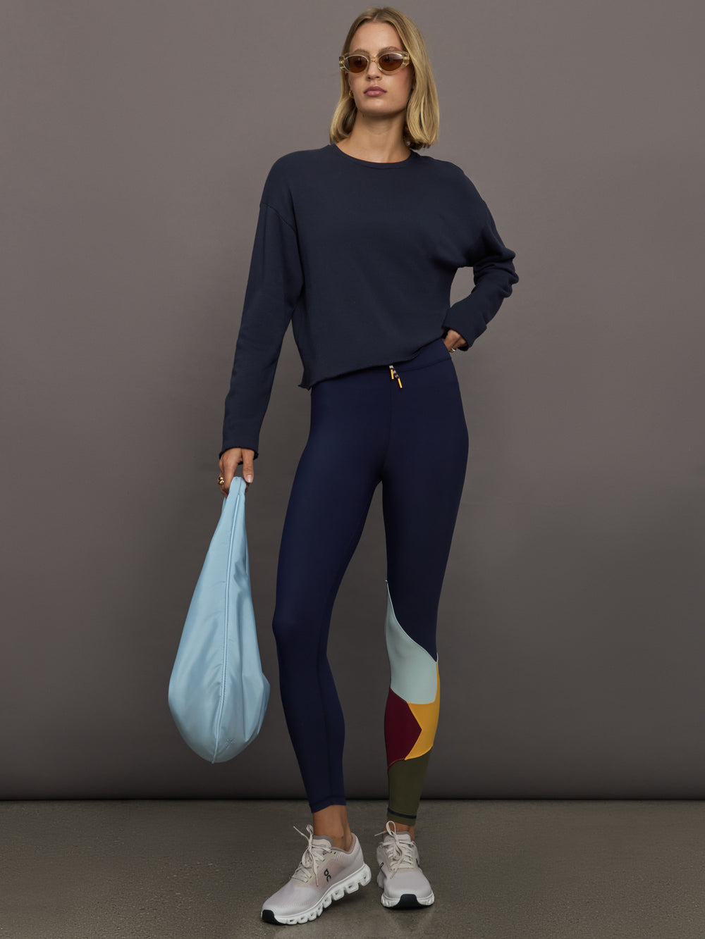Model wearing Navy leggings with colorful abstract design.