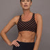 Woman wearing a checkered black and brown sports bra.