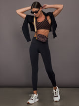 Woman wearing a checkered black and brown sports bra.