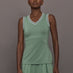 Model wears sage green tank top with a v-neckline and a fitted design.