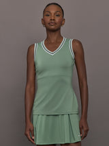 Model wears sage green tank top with a v-neckline and a fitted design.