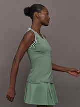 Model wears sage green tank top with a v-neckline and a fitted design.
