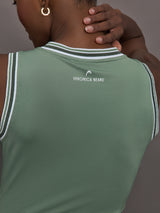 Model wears sage green tank top with a v-neckline and a fitted design.