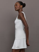 Model wears white tank top with a v-neckline and a fitted design.