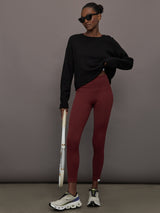 Model wears leggings in Terracotta with a waistband that sits just below the bellybutton and a length that ends slightly above the ankles.
