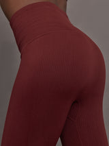 Model wears leggings in Terracotta with a waistband that sits just below the bellybutton and a length that ends slightly above the ankles.
