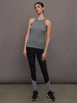 Model wears a heather gray high neck tank top. 