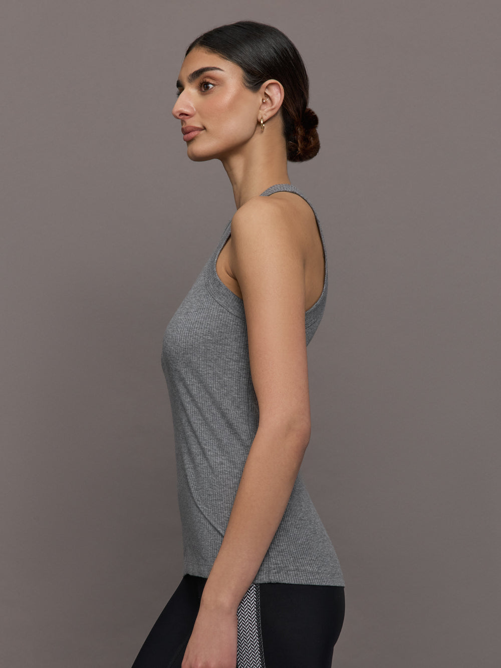Model wears a heather gray high neck tank top. 
