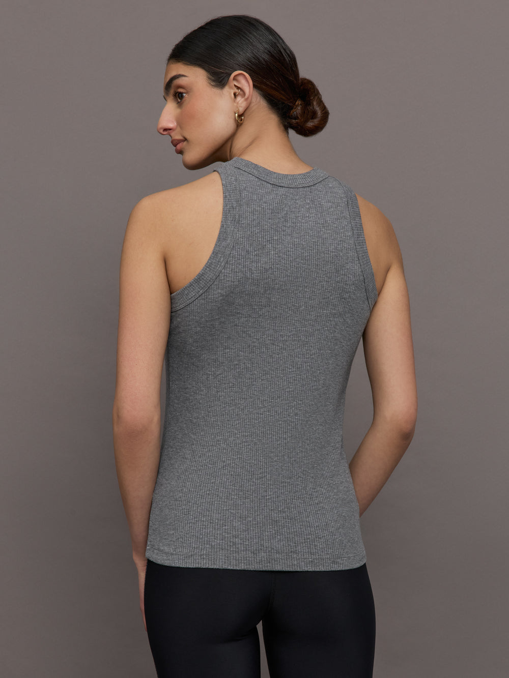 Model wears a heather gray high neck tank top. 