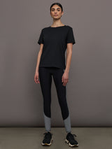 Model wears an oversized classic black tee shirt. 