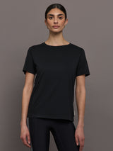 Model wears an oversized classic black tee shirt. 