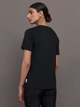 Model wears an oversized classic black tee shirt. 