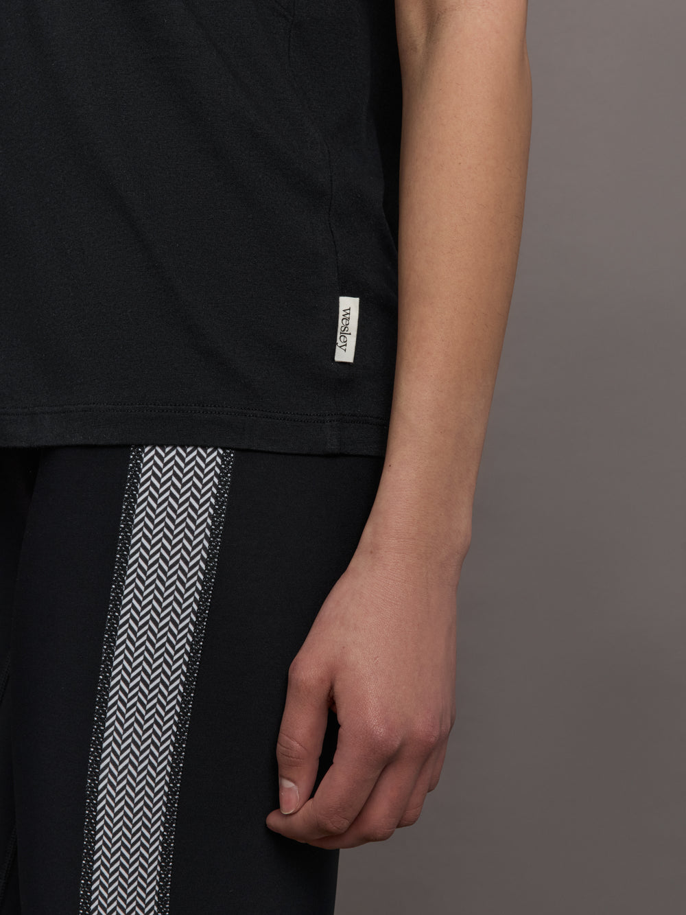 Model wears an oversized classic black tee shirt. 