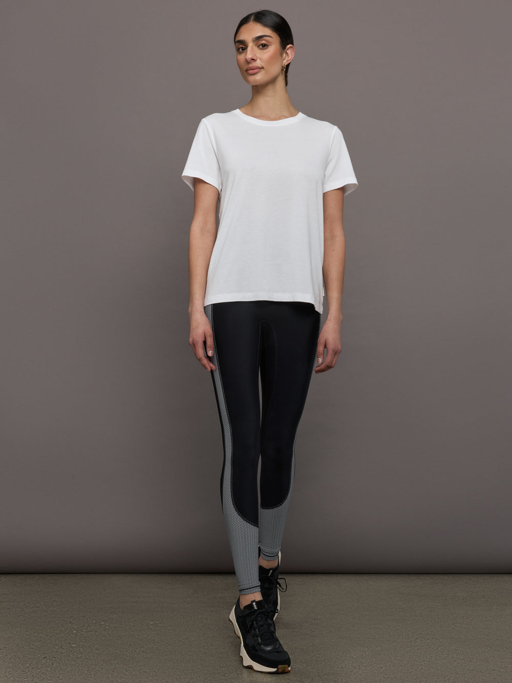 Model wears an oversized classic white tee shirt. 