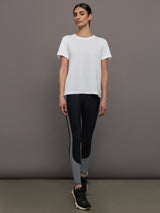 Model wears an oversized classic white tee shirt. 