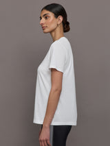 Model wears an oversized classic white tee shirt. 