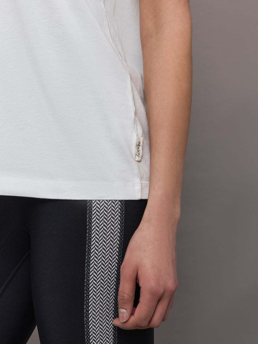 Model wears an oversized classic white tee shirt. 