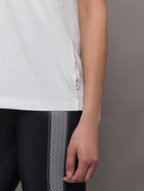 Model wears an oversized classic white tee shirt. 