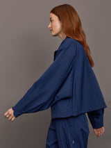 Model wears the Ulite nylon jacket in dark blue with a front zipper closure and relaxed fit.