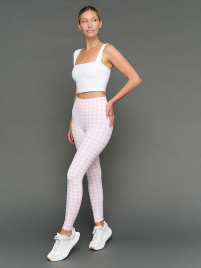 Model wears Gingham Leggings and a white sports bra on a grey background