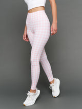 Model wears Gingham Leggings on a grey background