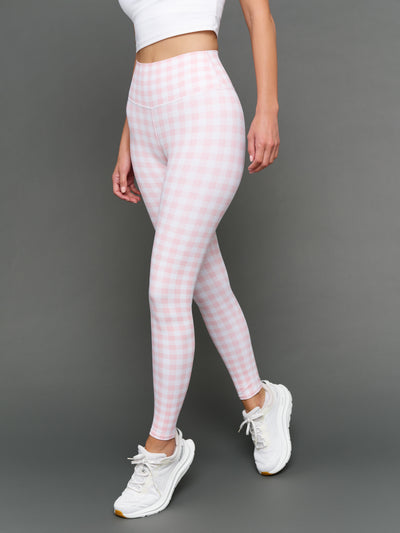 Model wears Gingham Leggings on a grey background