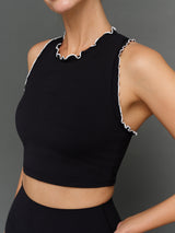 Model is wearing Melt scallop edge cropped bra in black white, front detail close-up.