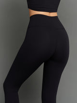 Model is wearing Melt scallop edge legging in black white, waistband and back detail close-up.