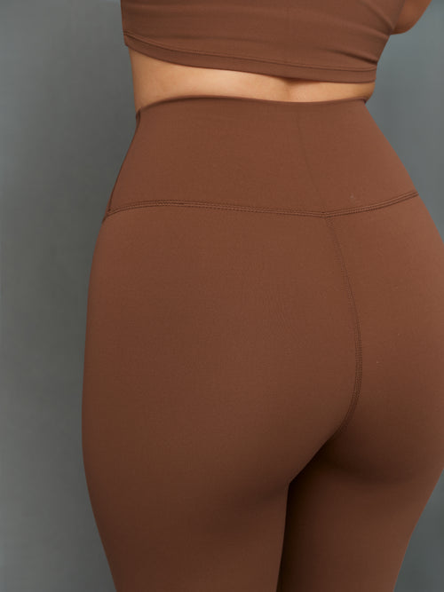 Model is wearing Melt scallop edge legging in carafe white, back close-up view.