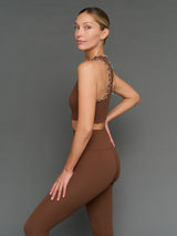 Model is wearing Melt scallop edge legging in carafe white, side profile view.