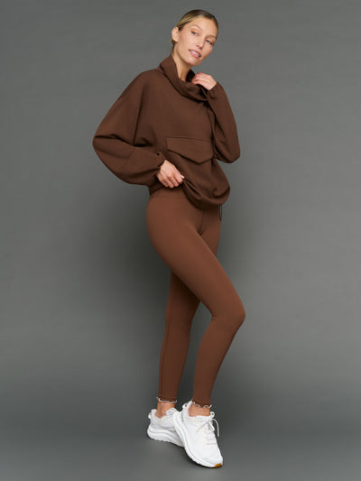 Model is wearing Melt scallop edge legging in carafe white, styled with pullover full body view.