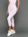 Model wears Gingham Capri Leggings on a grey background