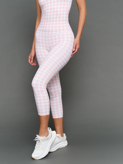 Model wears Gingham Capri Leggings on a grey background