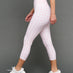 Model wears Gingham Capri Leggings on a grey background