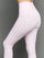 Model wears Gingham Capri Leggings on a grey background