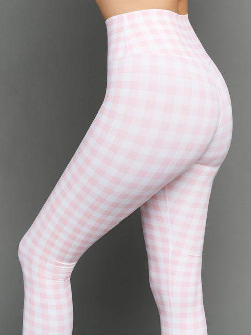 Model wears Gingham Capri Leggings on a grey background