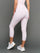 Model wears Gingham Capri Leggings on a grey background